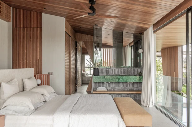 Guest bedroom at Livare Villa, timber ceiling and full height glazing onto planting